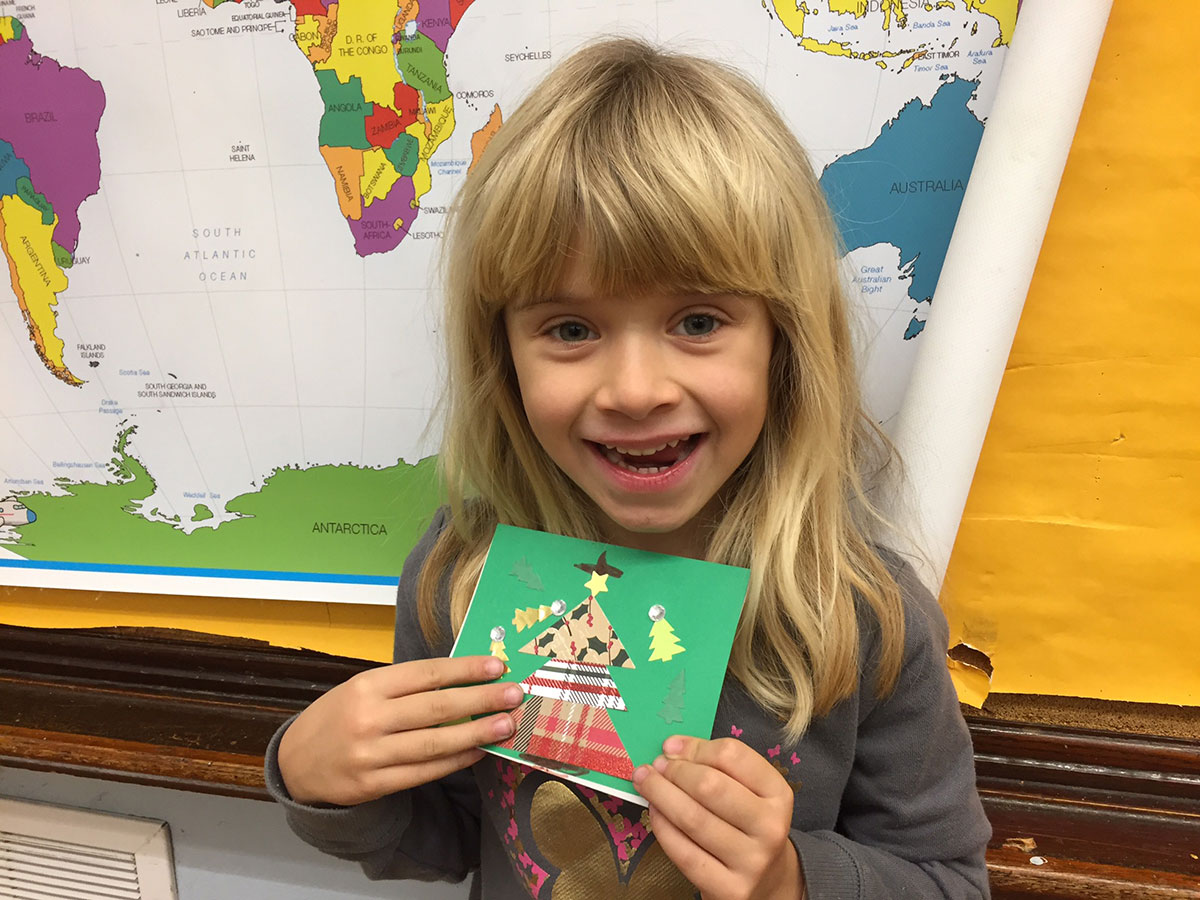 Student holds Christmas Card